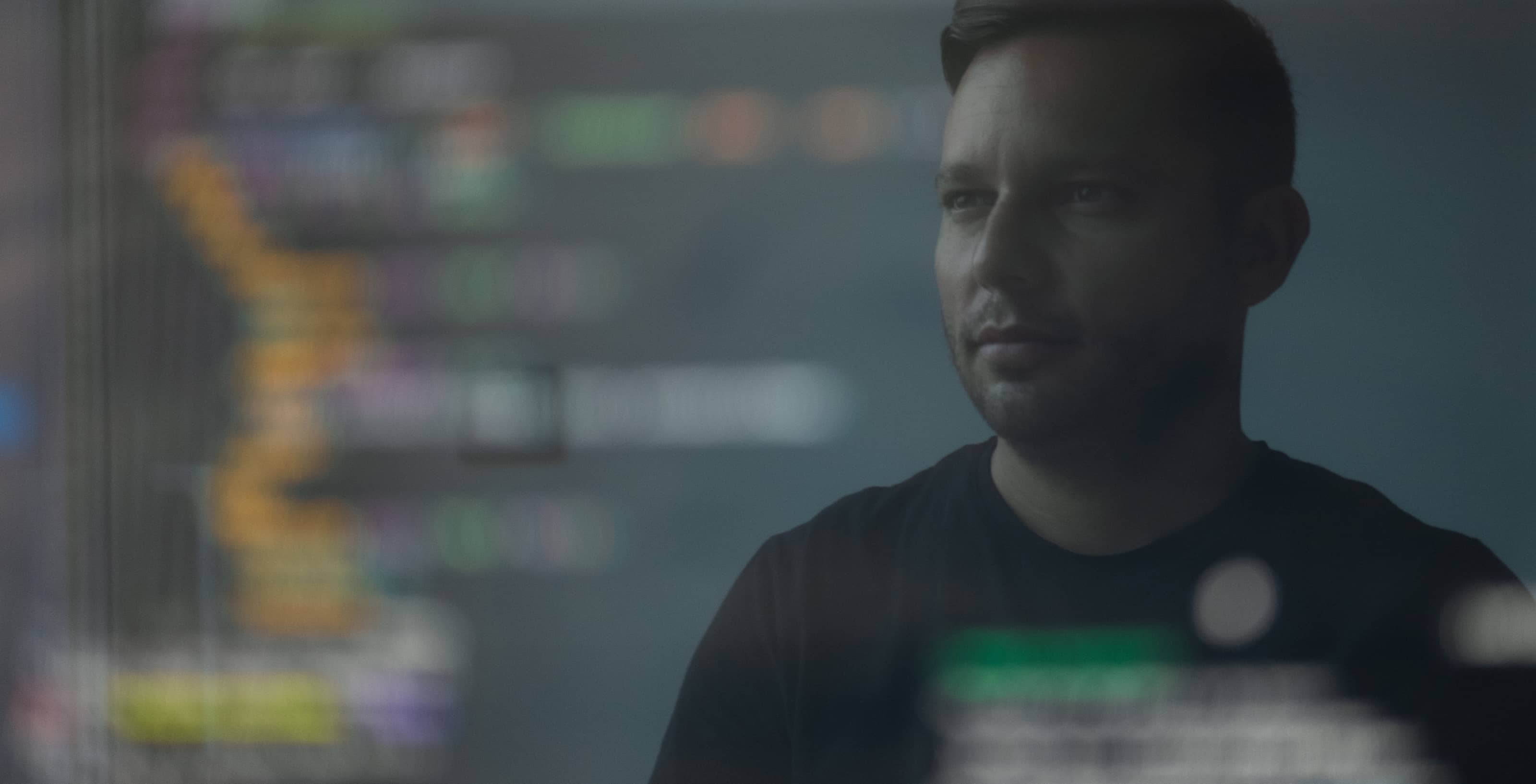 A person looking at the computer display showing programming code.