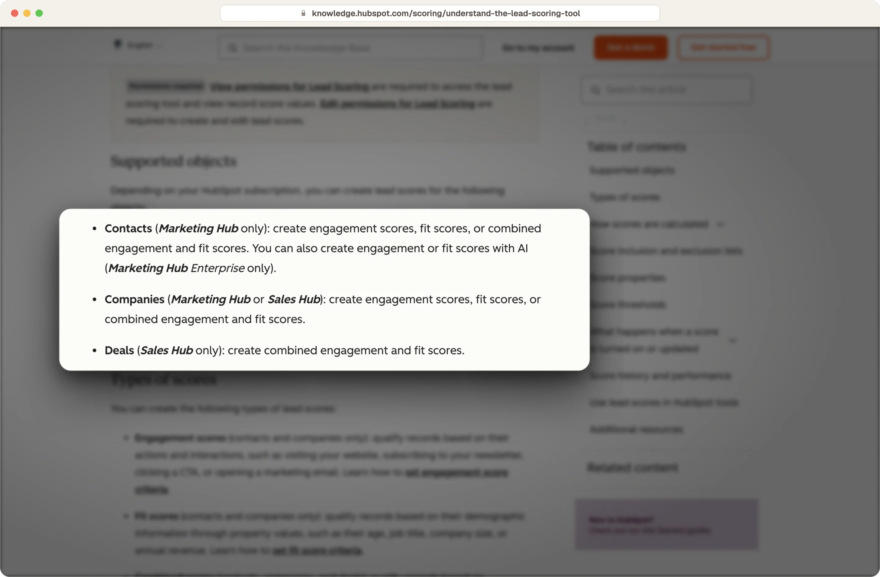 HubSpot knowledge base listing which hubs can score contacts, companies and deals, highlighted on the page
