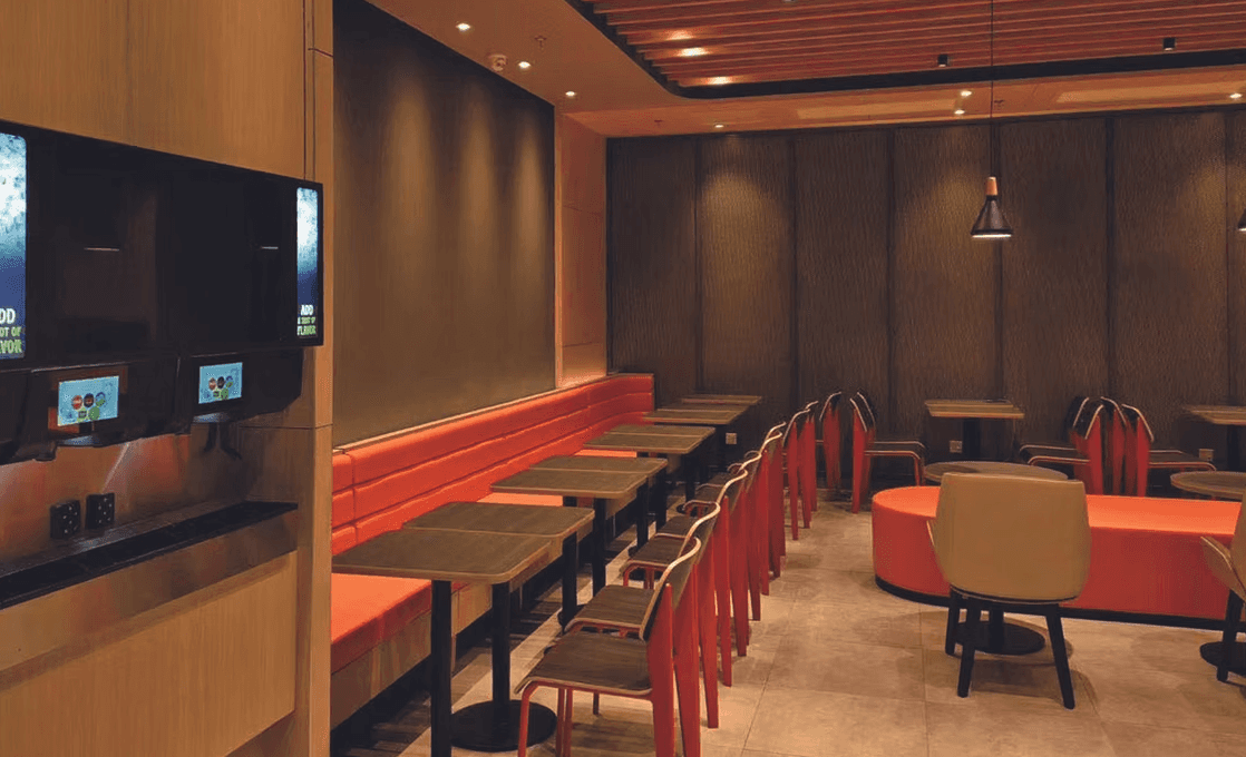 a restaurant with a large table and chairs