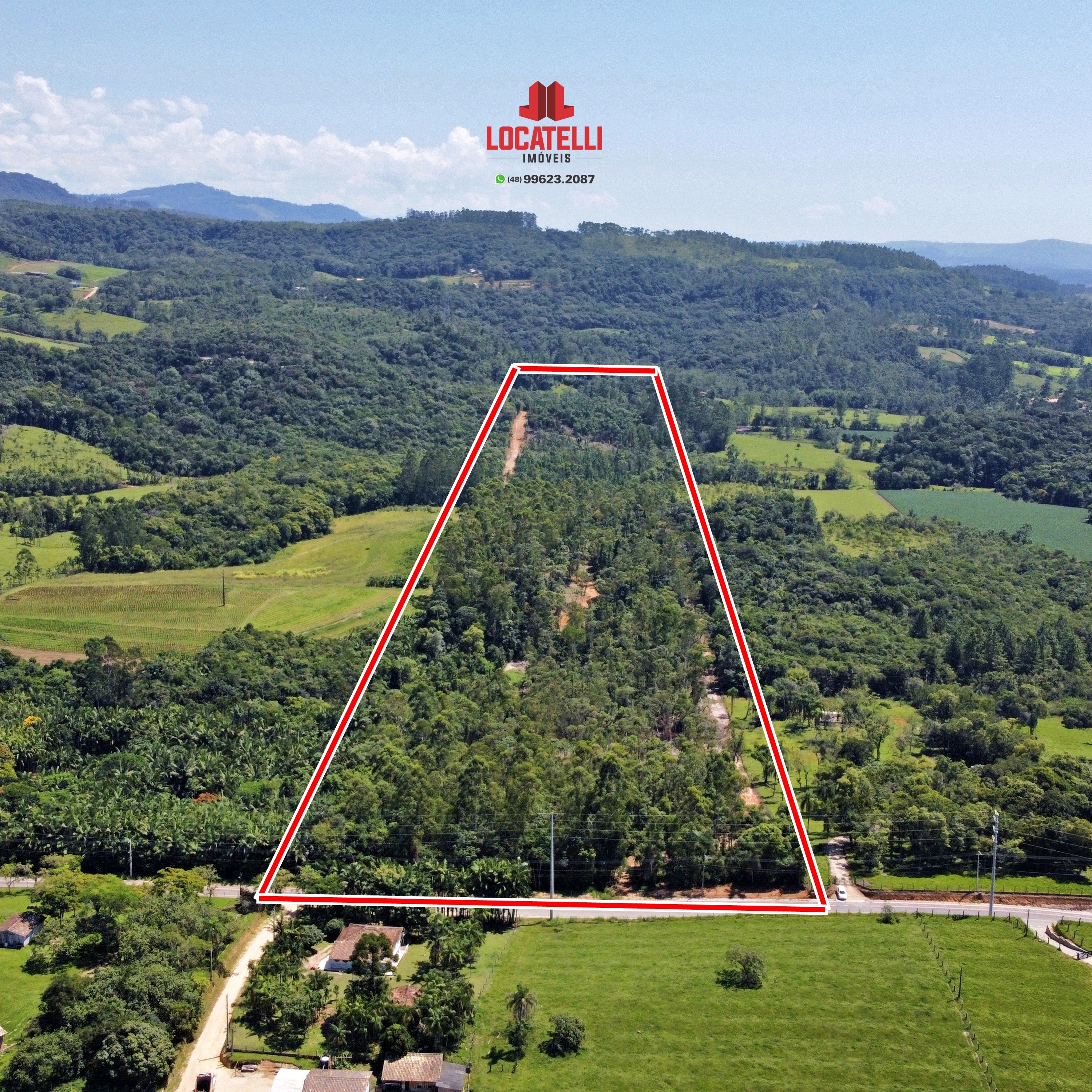 A modern brick house with a two-car garage, well-manicured lawn, and clear blue sky in the background.