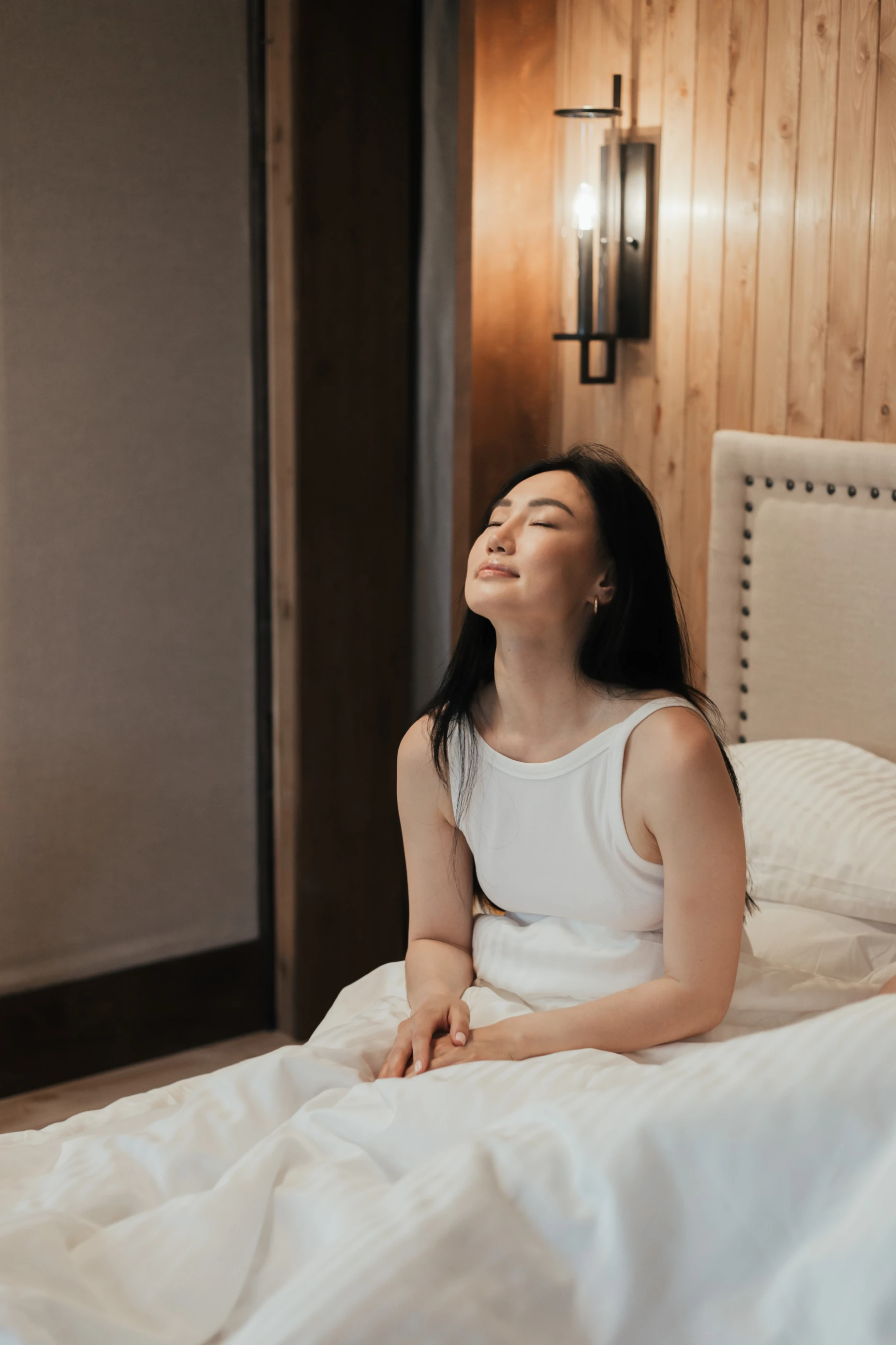 A woman relaxing and self-soothing in bed