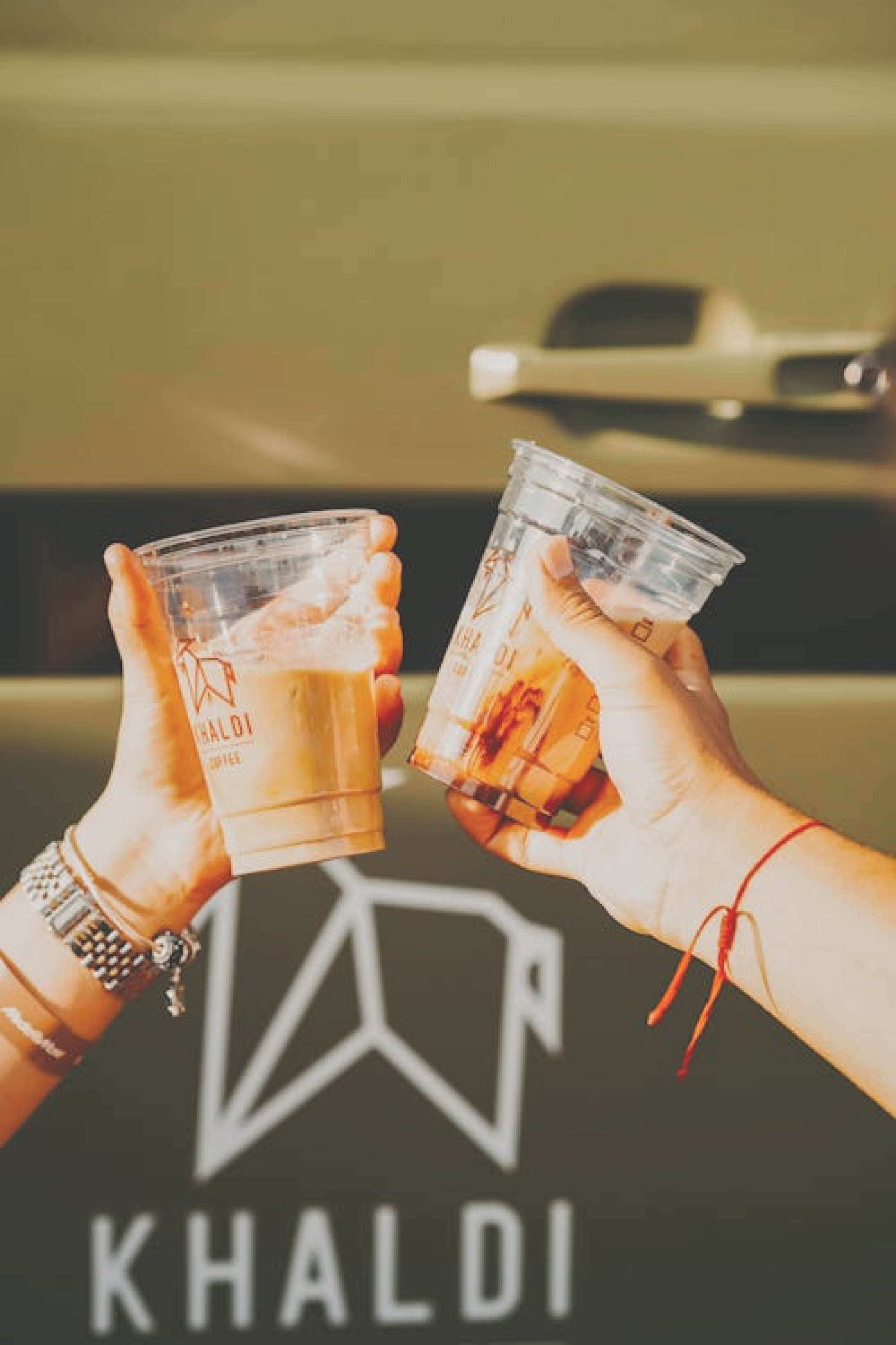 Two hands holding take out coffee cups