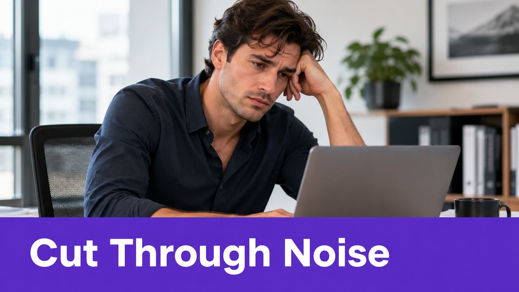 A tired business professional looking stressed while working on his laptop in a modern office environment.