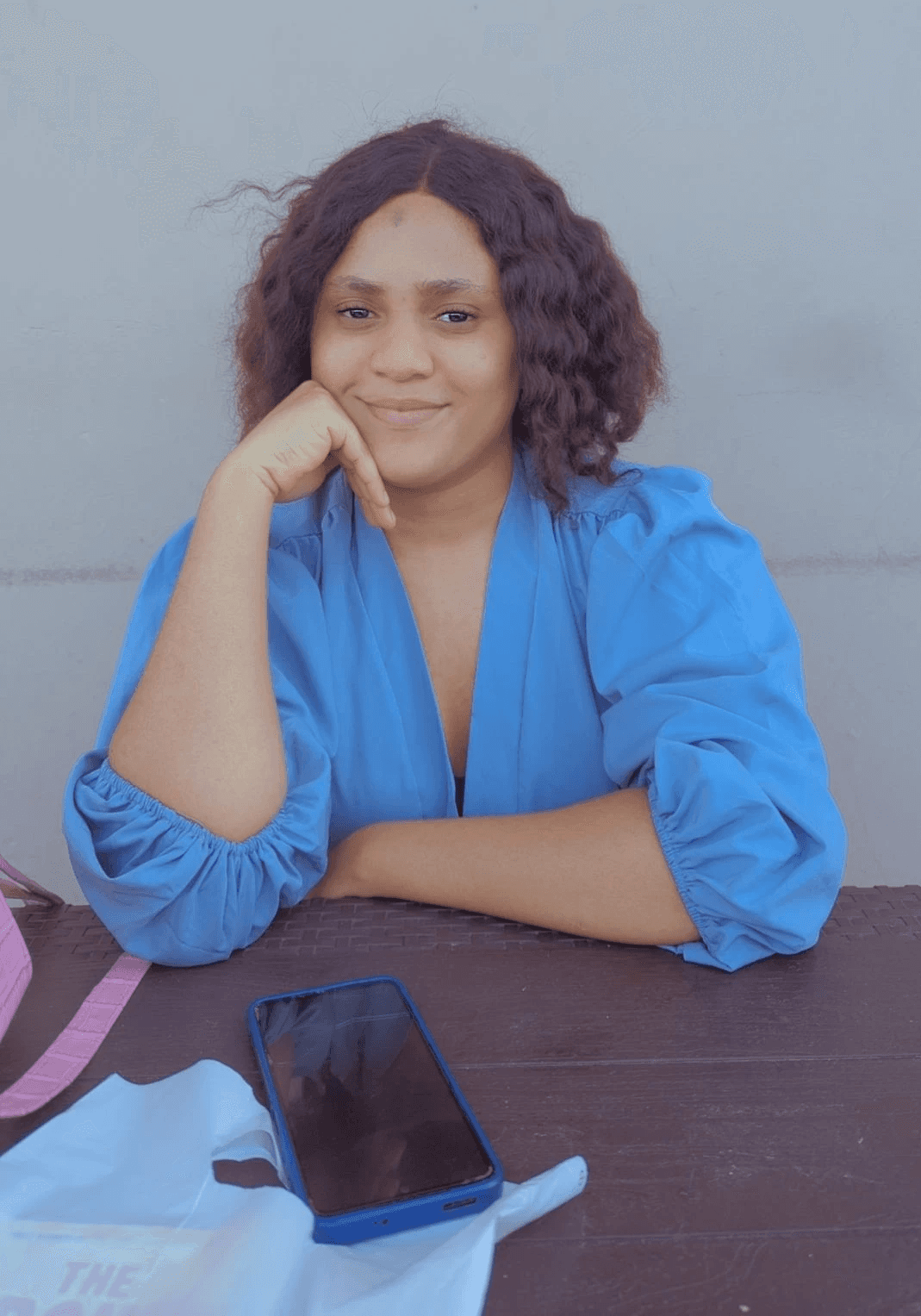 a woman with an afro is looking at the camera