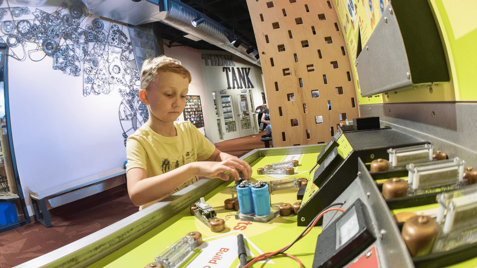 A young boy puts together different circuits.