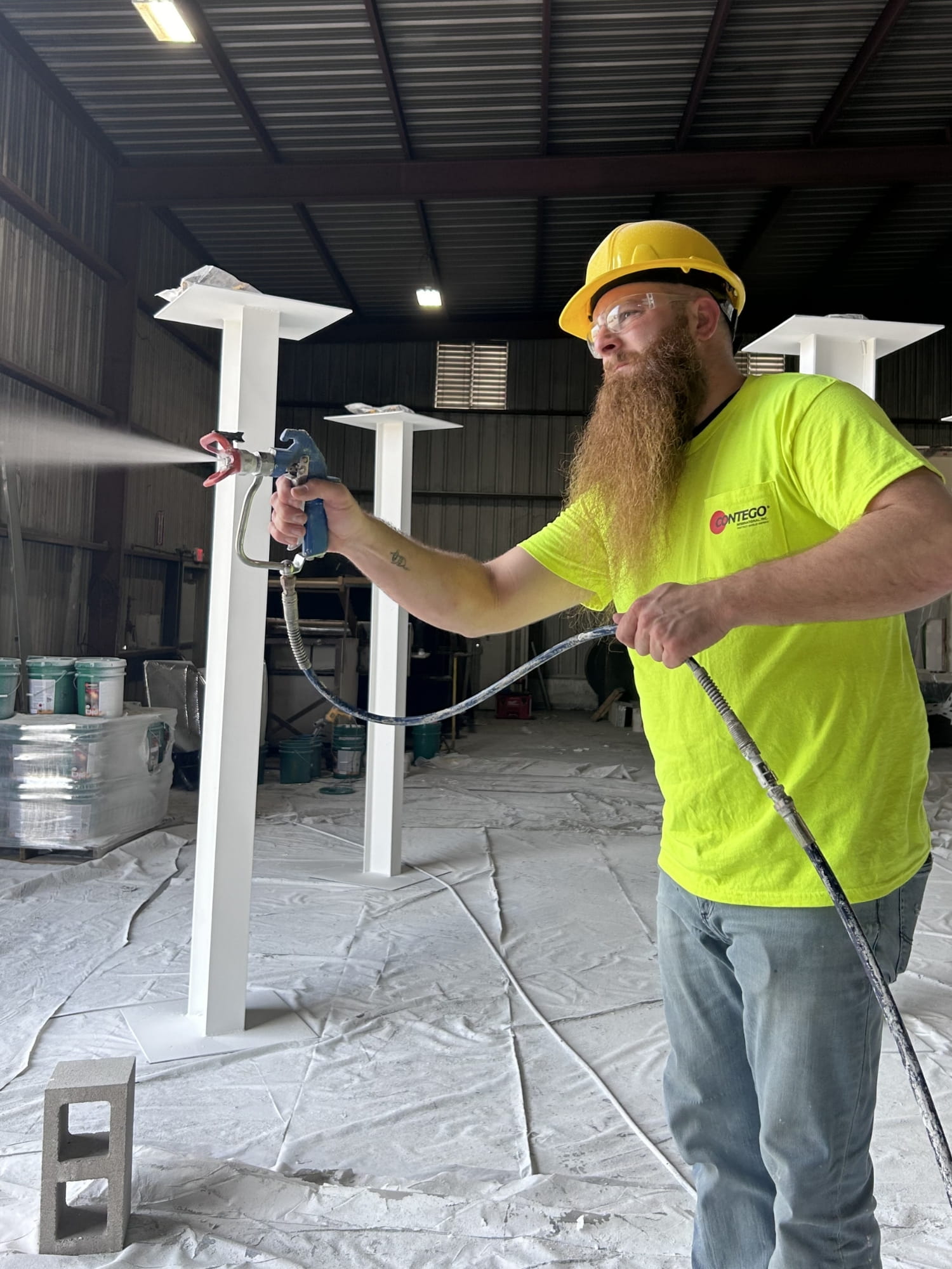 Spray on fireproofing being applied by Contego Team