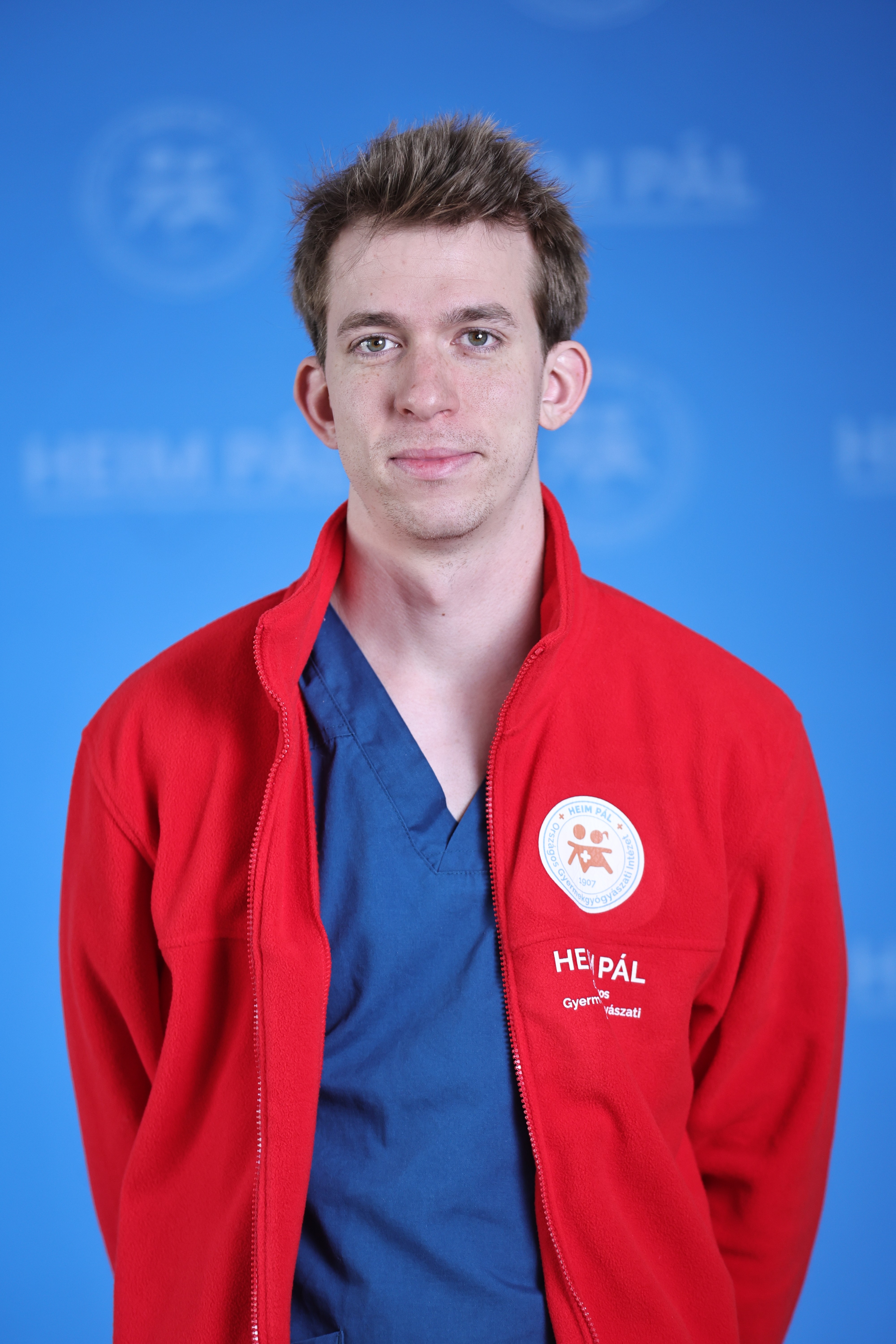 Rövidhajú férfi piros kardigánban