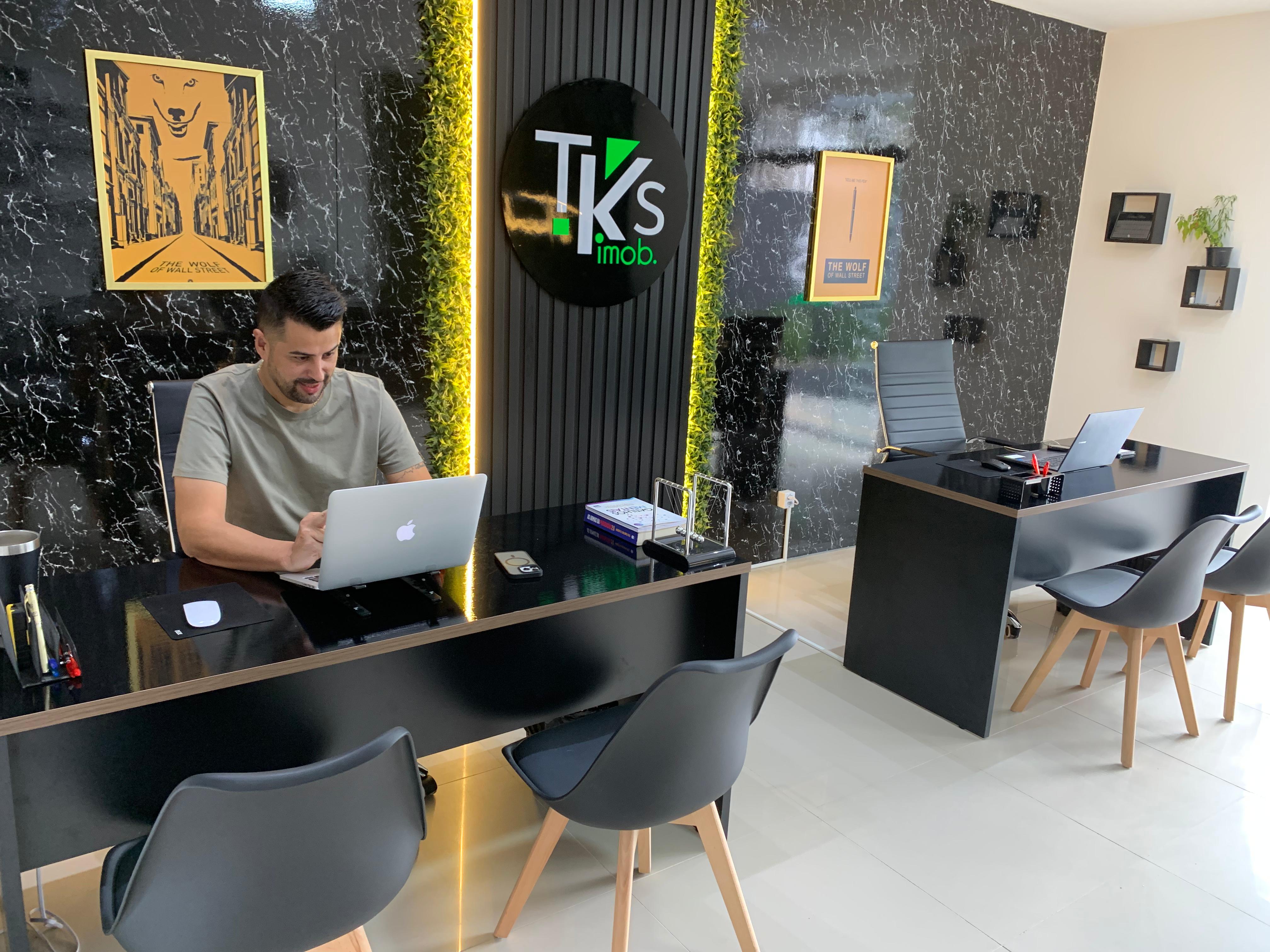 An image of a white apartment building in perpective view with several floors and windows.