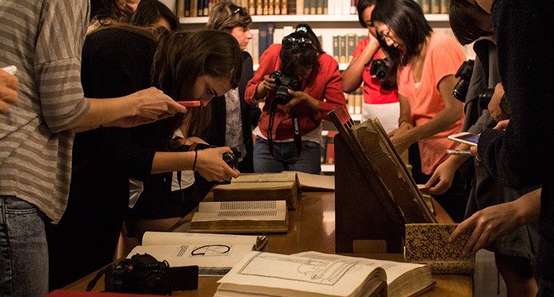 students looking at the old books
