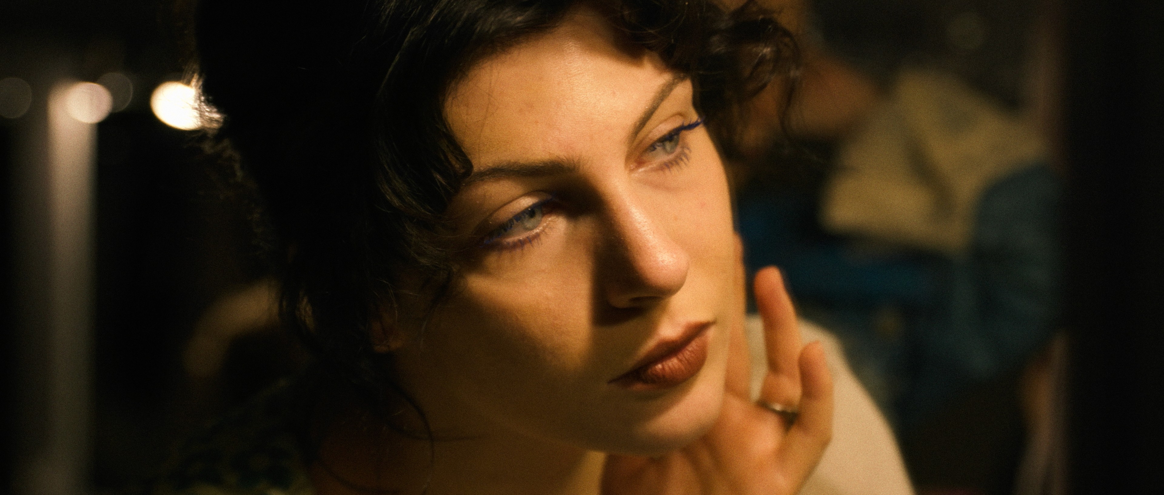 Cinematic portrait of an actress with soft lighting, still frame from AST Kraków commercial.