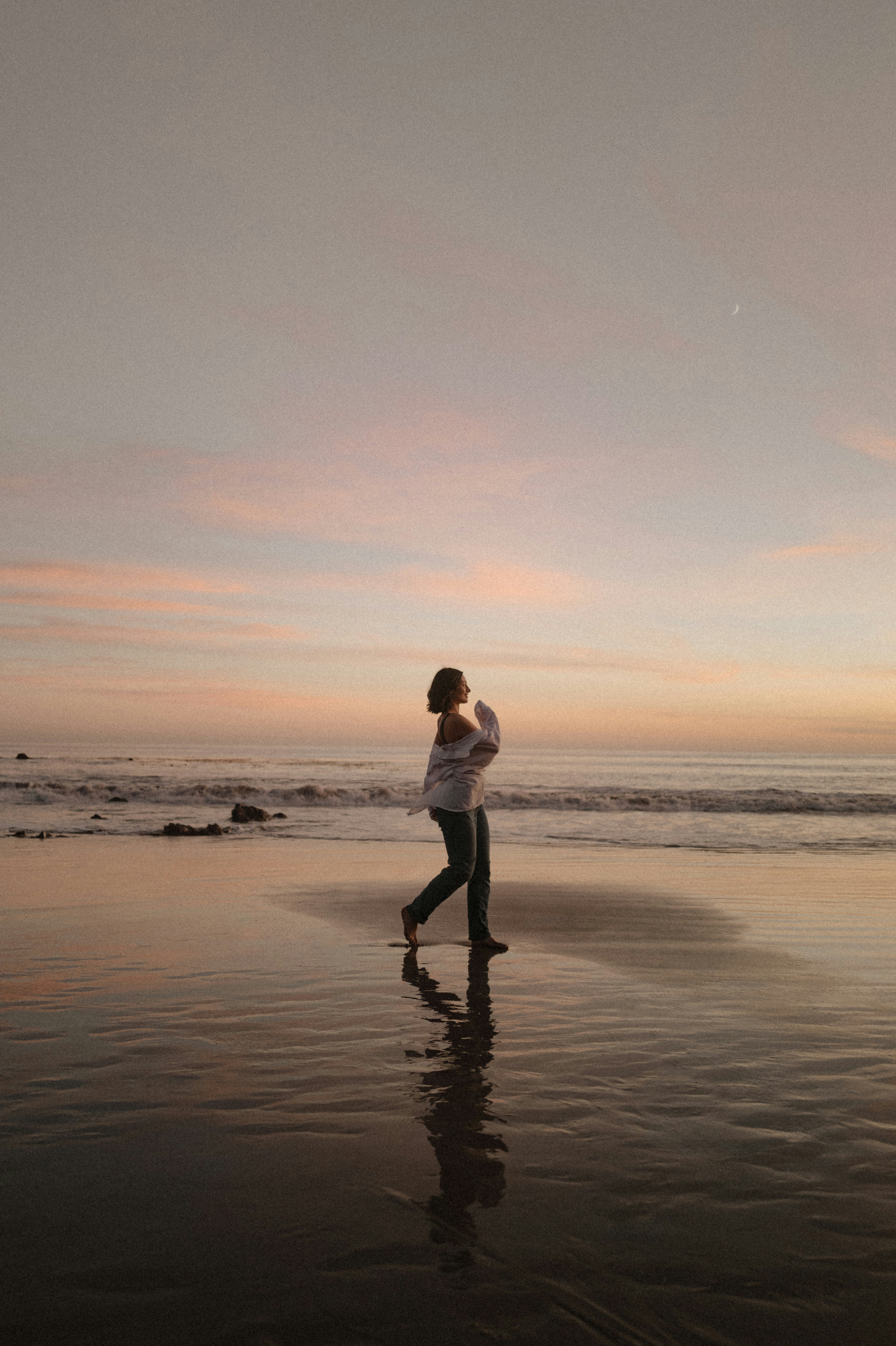 Woman wears a blue coat in a blue environment.