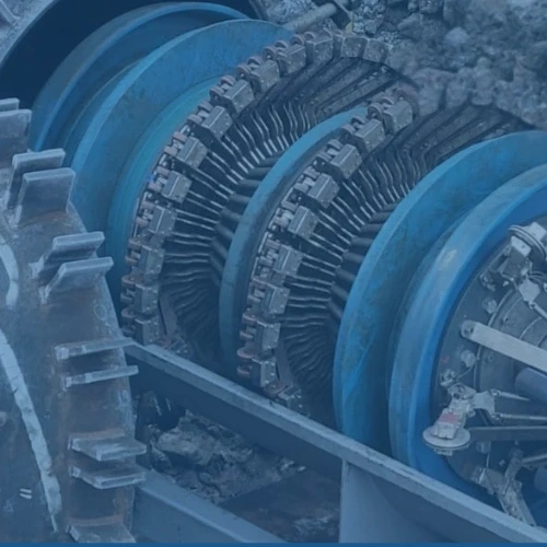 Close-up view of industrial machinery components featuring gears, circular blue structures, and metal parts.