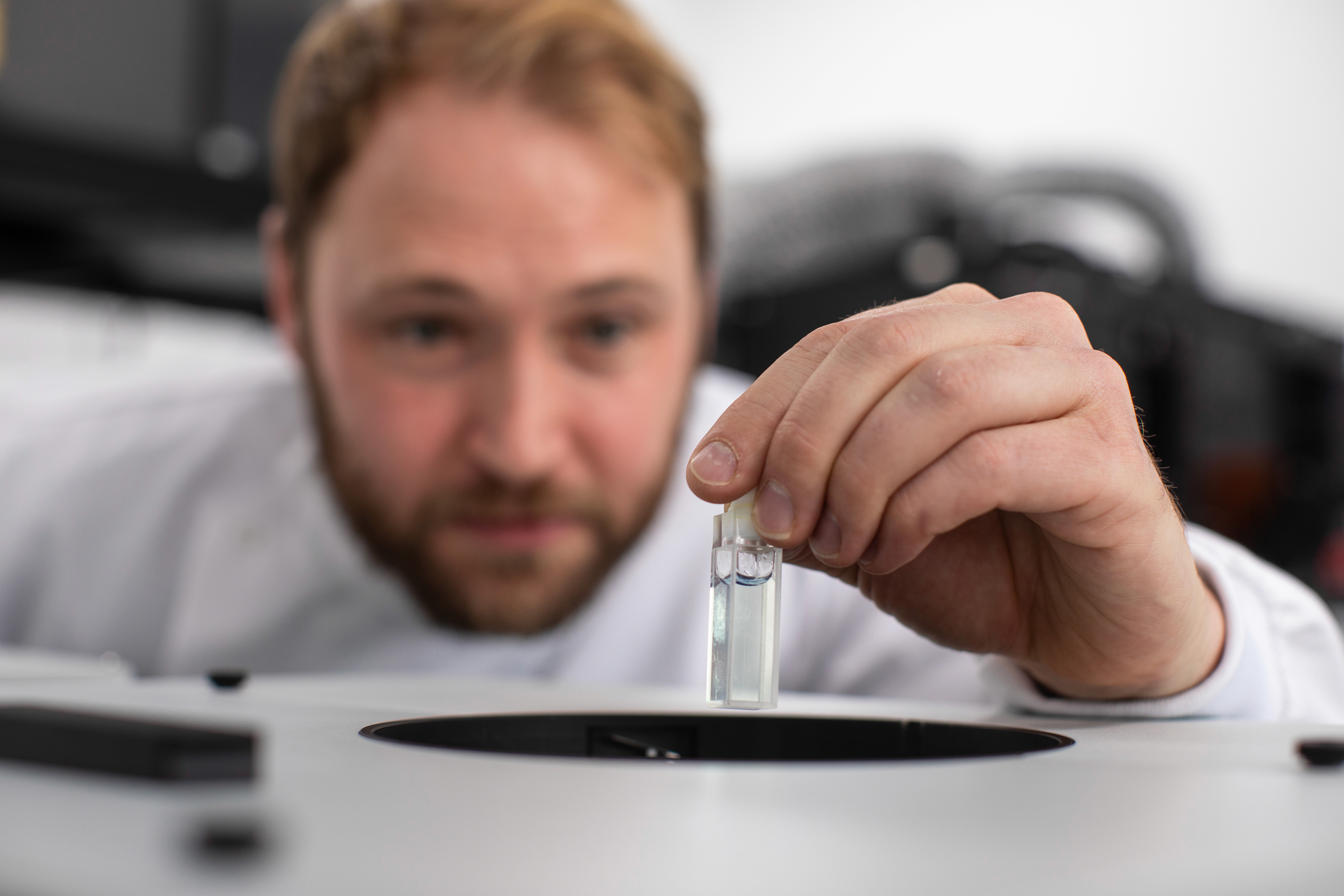 CPI scientist inspecting a liquid in a vial.