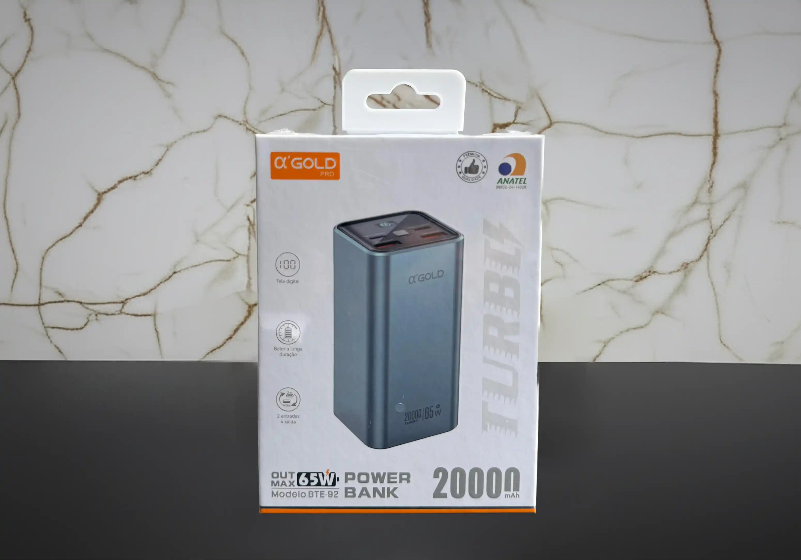 Caixa do power bank α'GOLD PRO 20000mAh 65W modelo BTE-92, imagem do produto azul, selo ANATEL e indicação "Power Bank 20000 mAh"