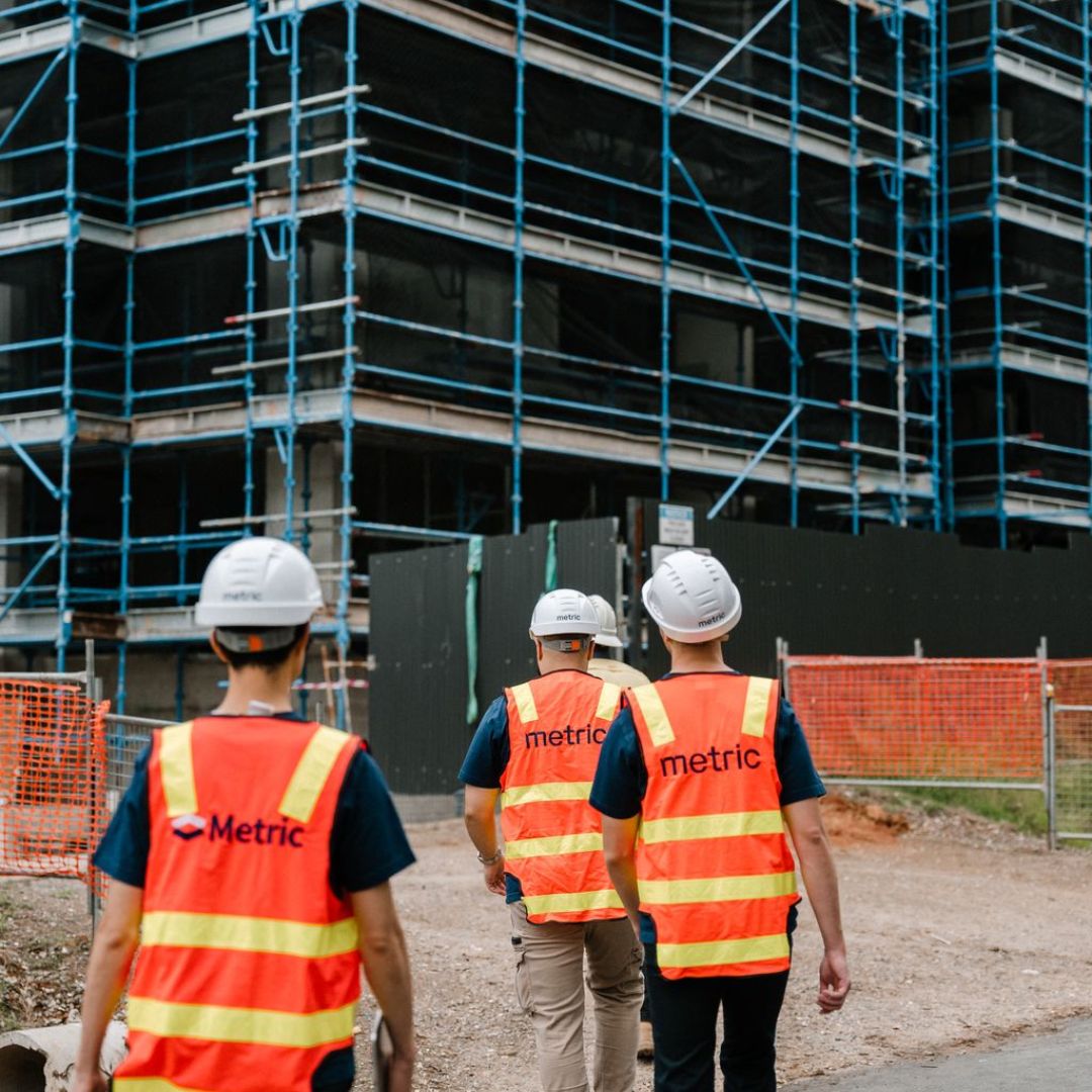 man standing near high-rise building
