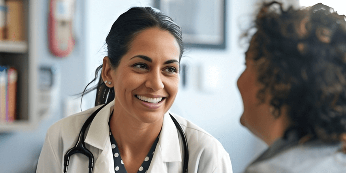 Smiling female doctor holding a clipboard and discussing results with a patient during a consultation at Venus Women's Health.