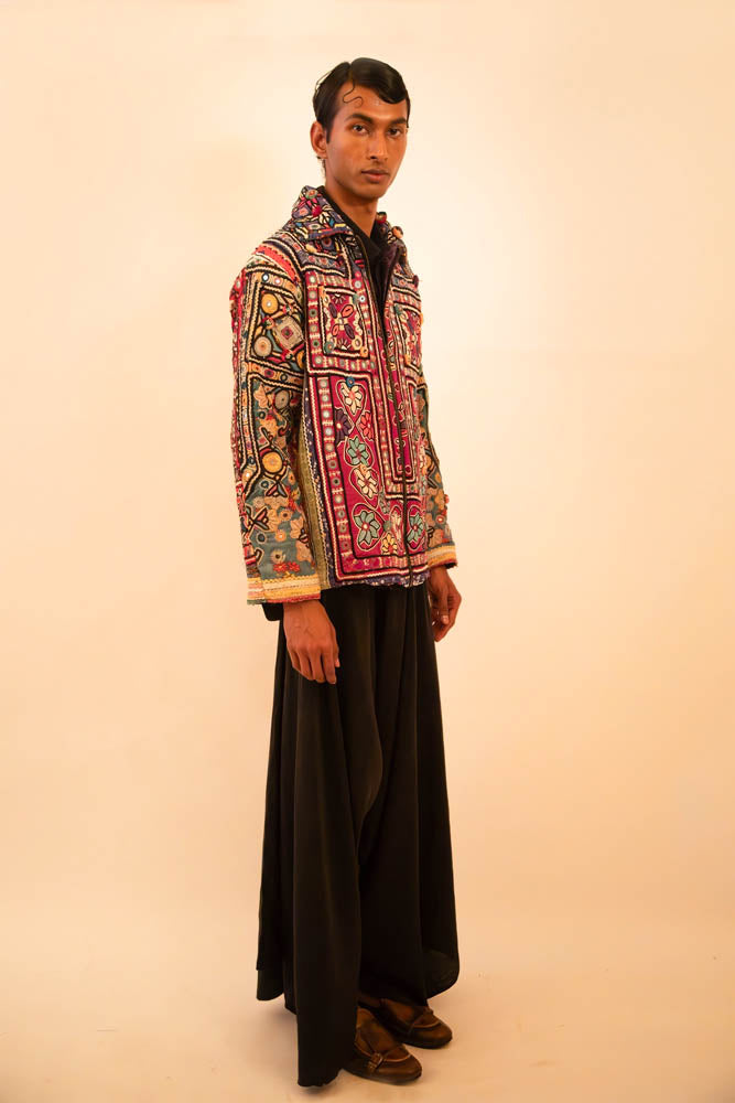 One-of-a-kind jacket handcrafted from traditional Rabari cholas panelled together, lined with a vintage silk sari, featuring a boxy fit with dropped shoulders.