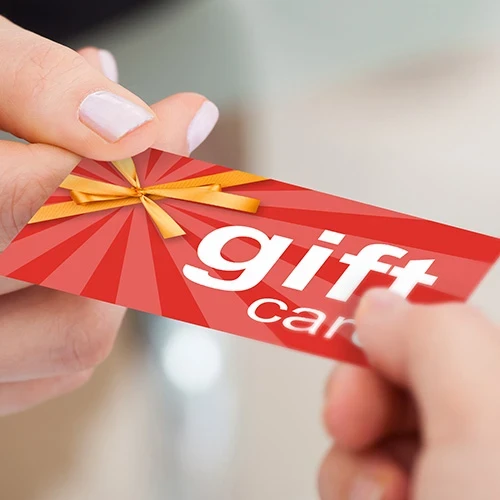 Person Hand Giving Gift Card To Another Person