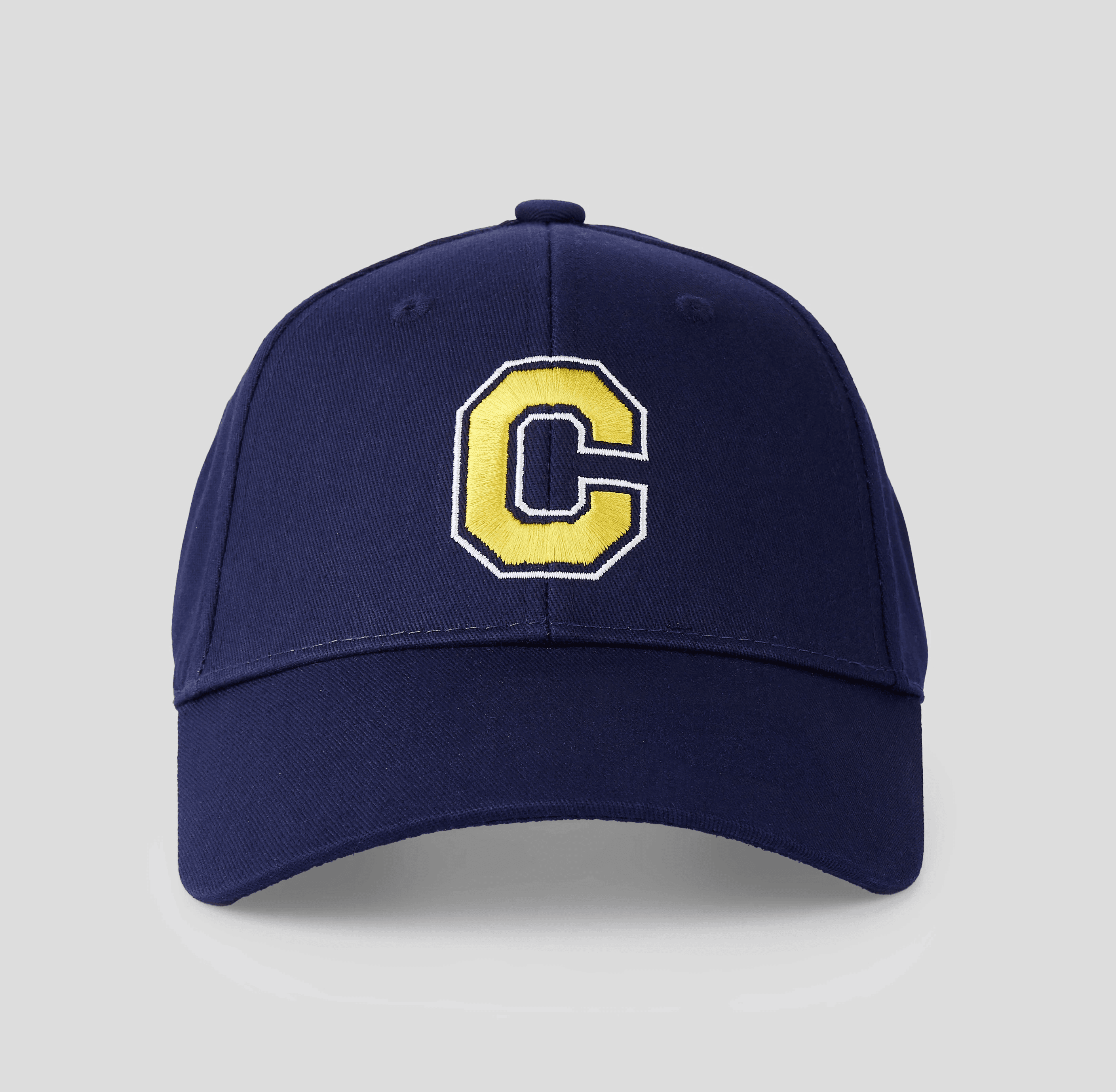 A blue baseball cap with a brown "Old Town" logo patch on the front, featuring a cardboard tag attached to the brim, displayed on a light gray background.