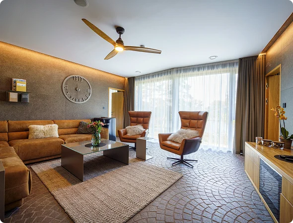 Luxury modern bedroom interior with warm lighting, wooden accents, and cozy seating area