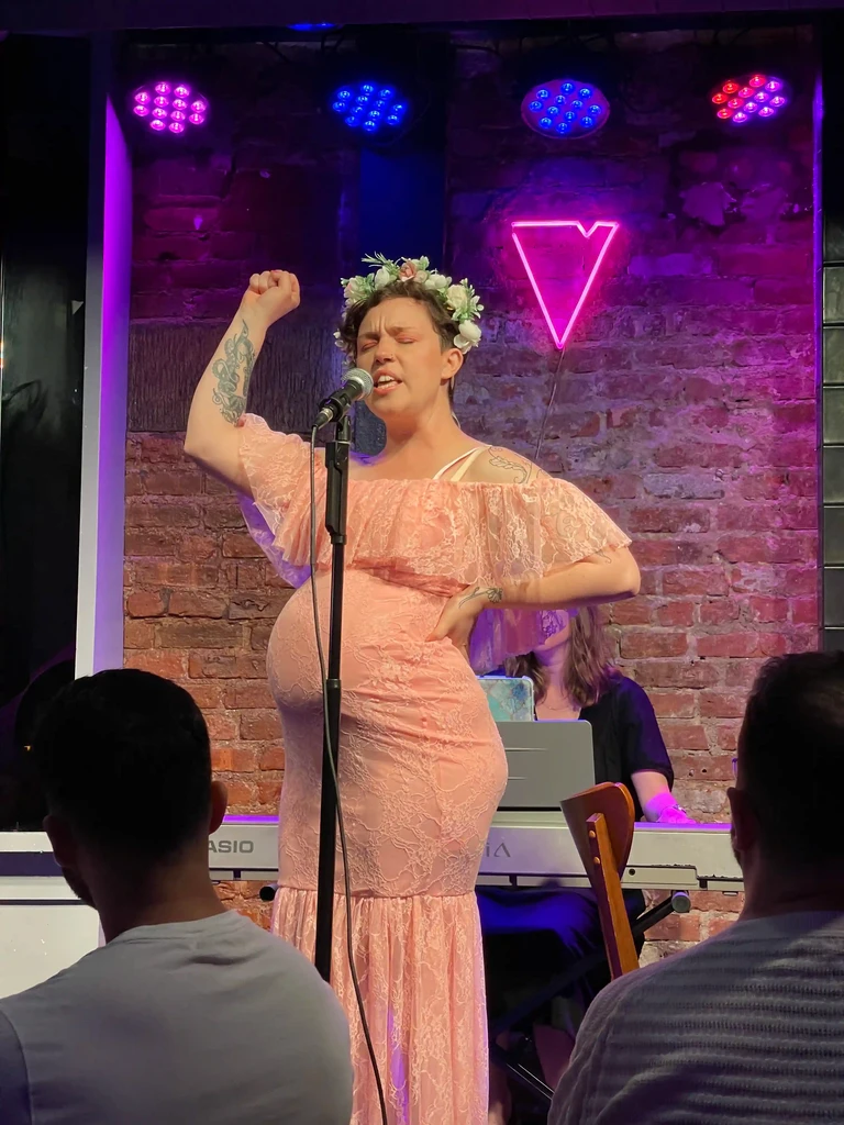 A performer raises a fist at the end of a number