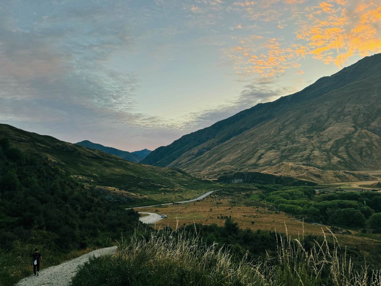 Man walking a long road towards a huge mountain