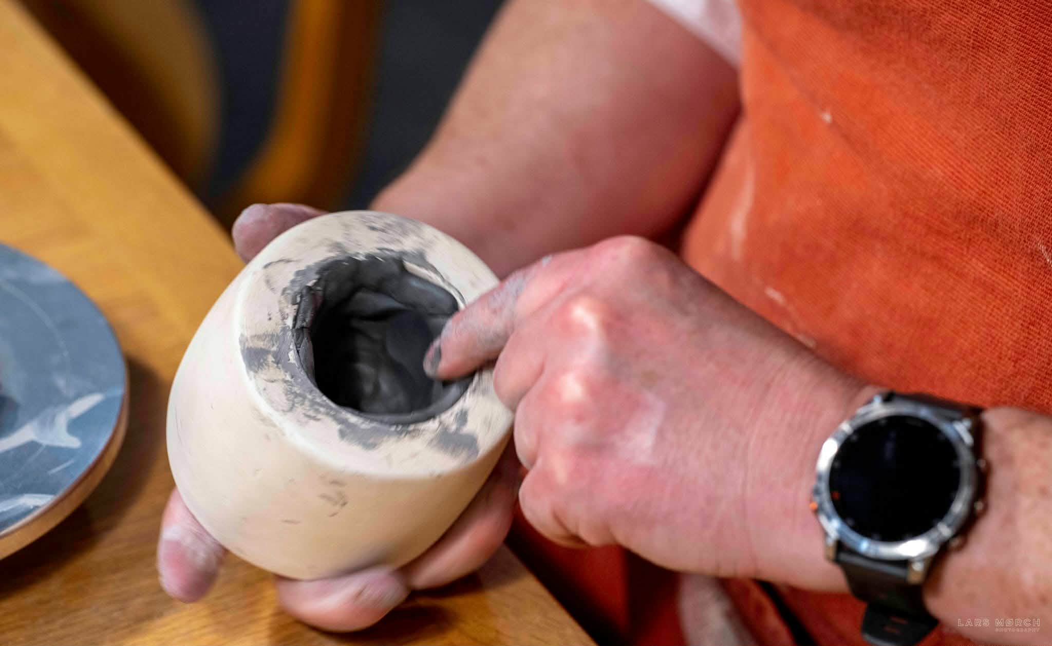 pressing clay into a casting mould