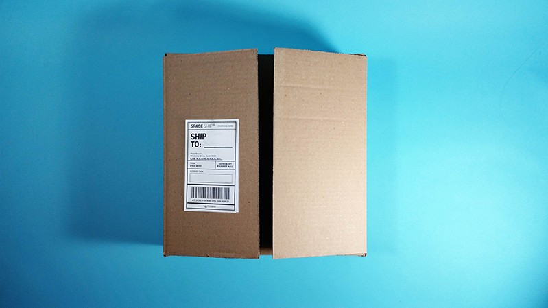 A photo of a closed card box placed on a blue table.
