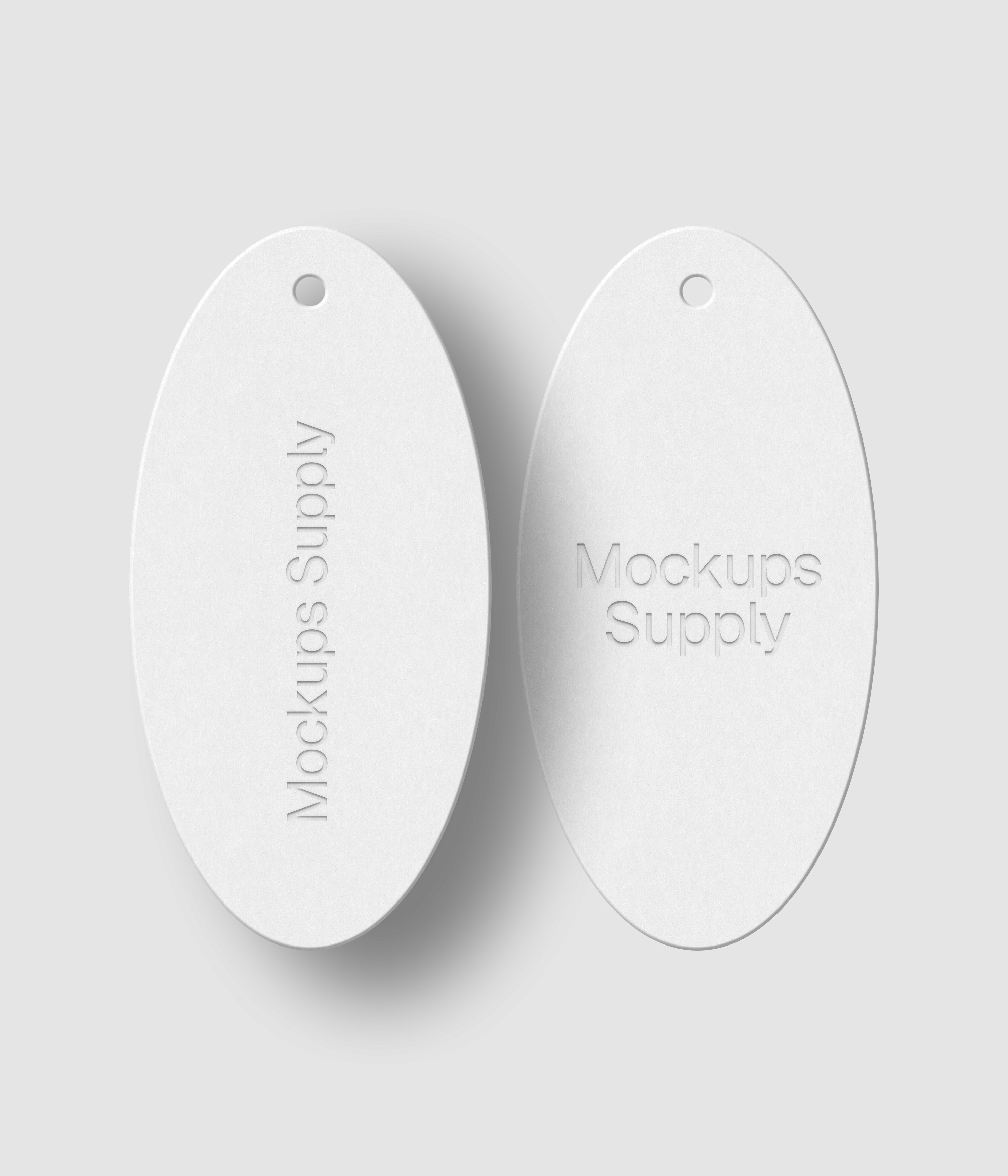 Two white oval hang tags with debossed text effect and realistic shadow on white background photoshop PSD mockup template set