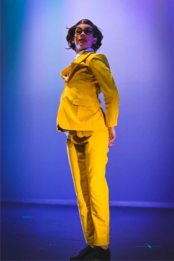 Girl on stage in yellow suit