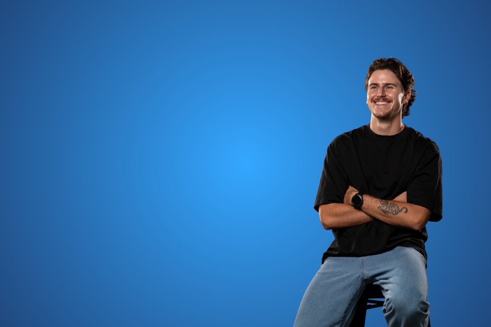 Bailey smiling with arms folded