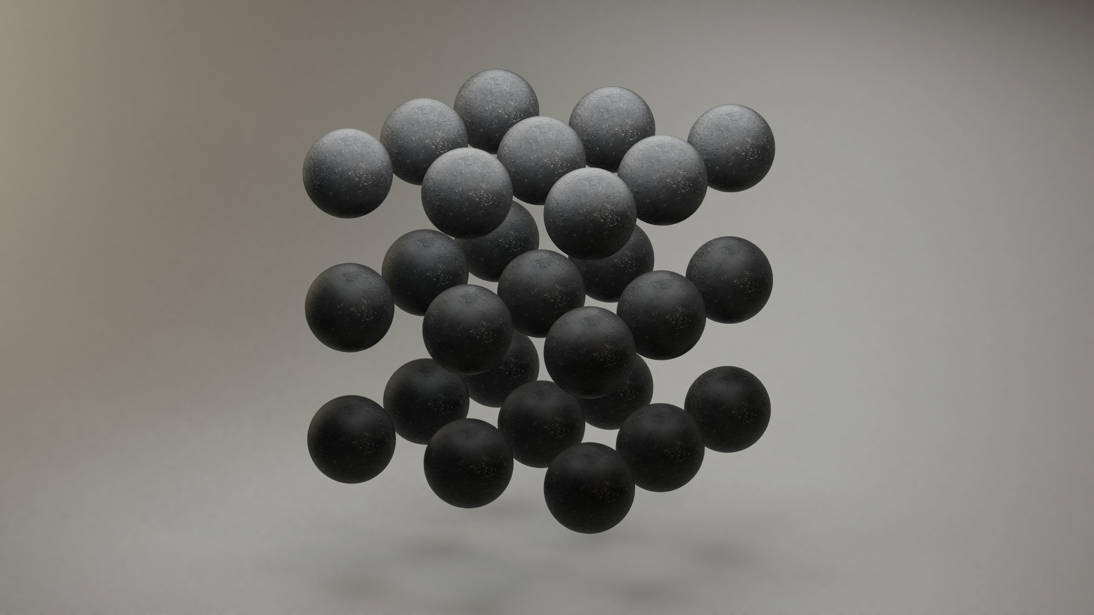 Floating cluster of matte black spheres in minimal studio lighting