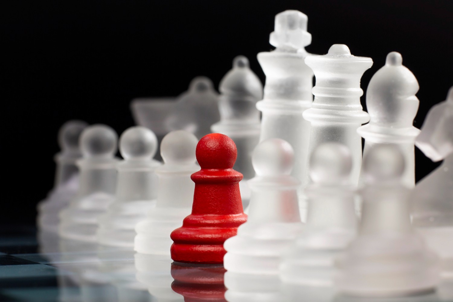 Red chess piece standing out among others representing competitive advantage through PPC services in the UK with strategic digital marketing by Guideway Media