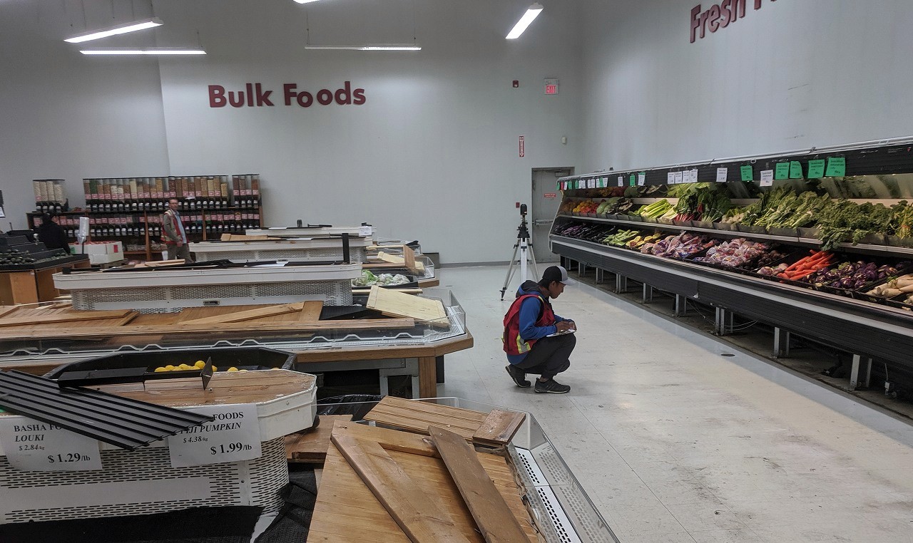 Engineering team conducting floor survey and damage assessment