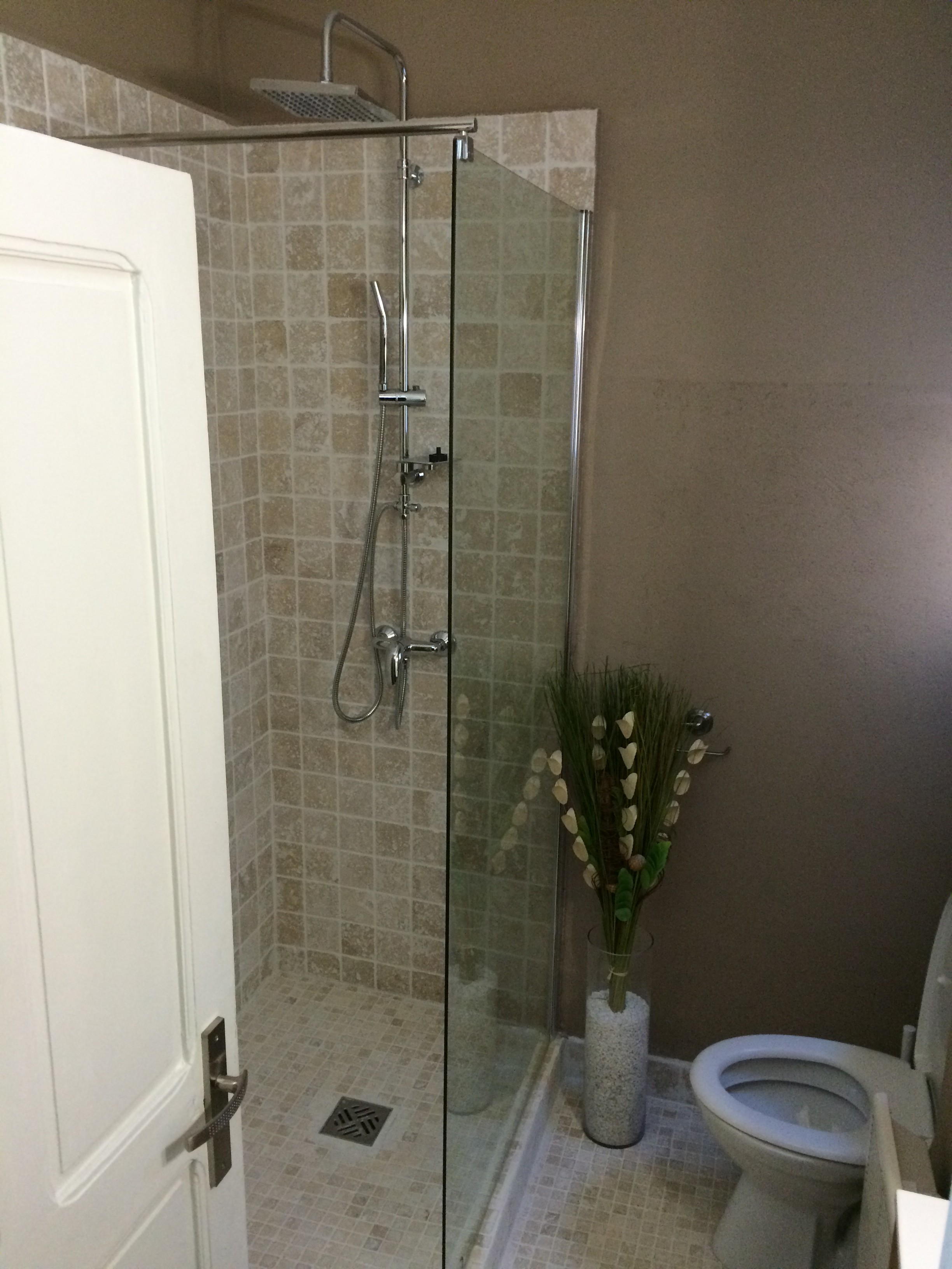 Luxurious living room with a gold geometric screen, dark wood paneling, plush sofa, and a glowing lamp on a side table. Modern and elegant ambiance.