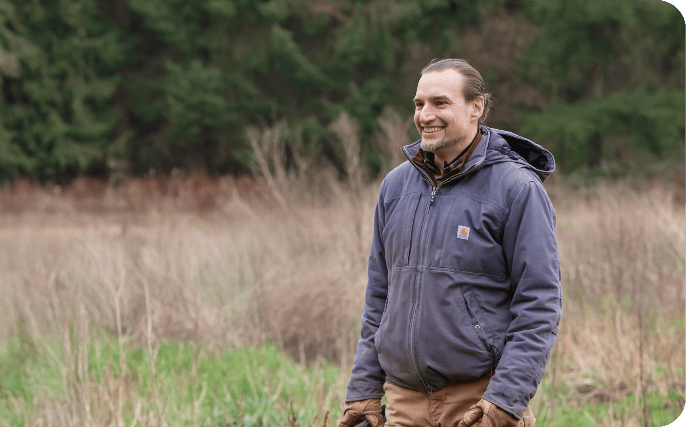Eduardo walking outdoors on the land.
