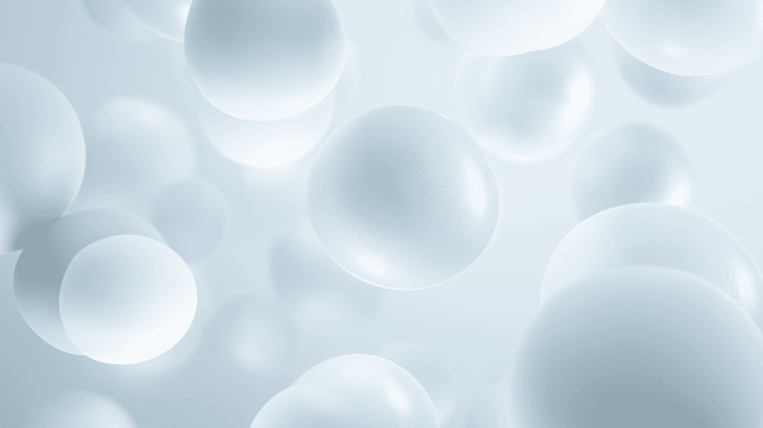 Floating white spheres on a light blue background, creating a serene and airy atmosphere. The spheres vary in size, adding depth and softness.