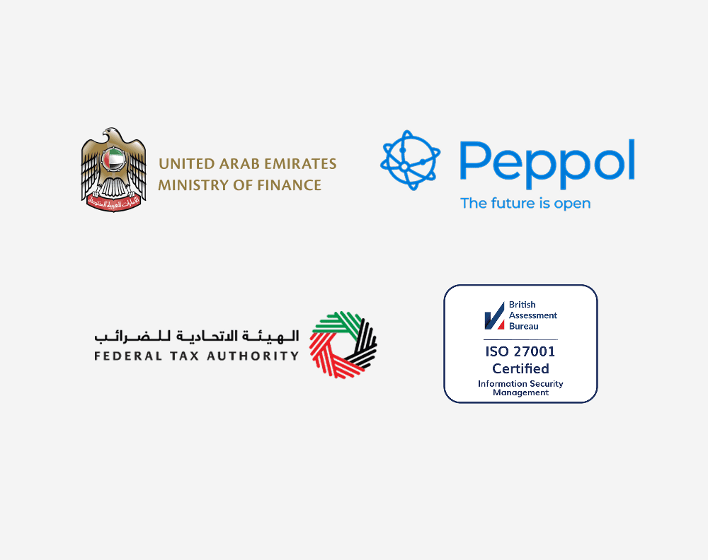 A young person with curly hair smiles at the camera while sitting in front of a laptop against a dark background.