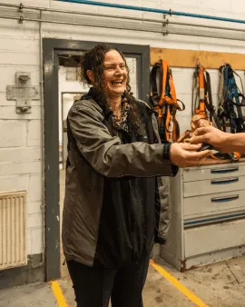 Hands pressing through red and blue illuminated fabric