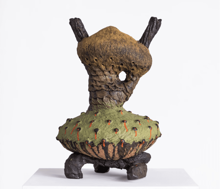 Andile Dyalvane, Isiduli (Anthill), a glazed earthenware sculptural vessel with an irregular anthropomorphic form in ochre, green, brown and red.