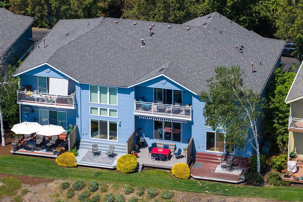 Vibrantly saturated aerial drone photography of a lakefront condo with balcony and deck