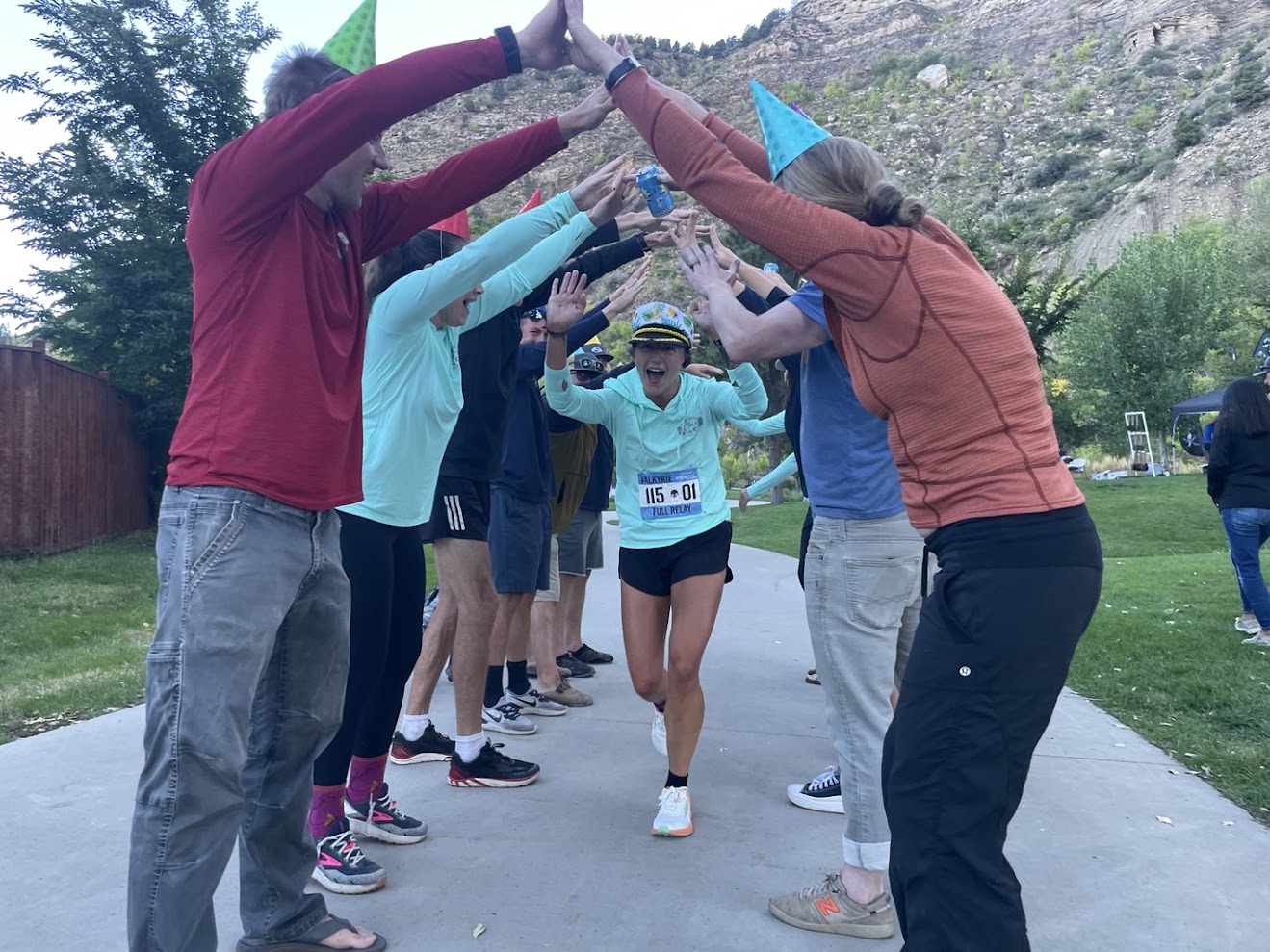 Teams forming a high-five tunnel for a finishing racer