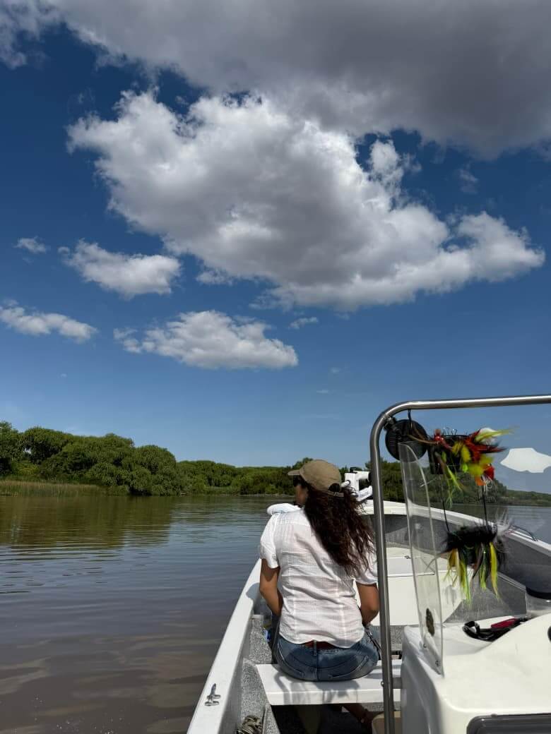 Traditional fly fishing boat navigating the wild streams of Buenos Aires