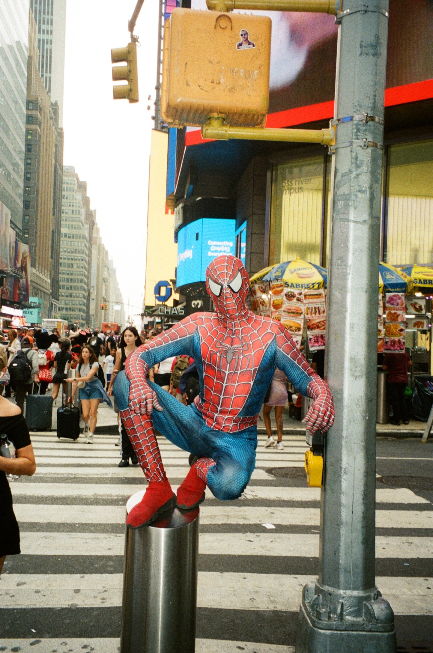 Person in Spider-Man costume posing on a city street