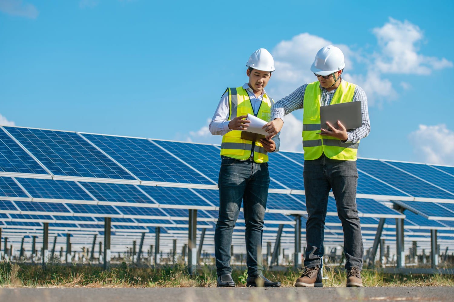 Engineers with solar panels and a laptop