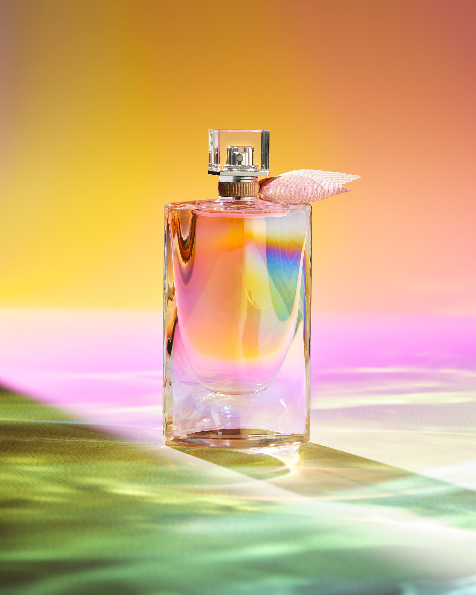 Elegant perfume bottle with vibrant, colorful background.