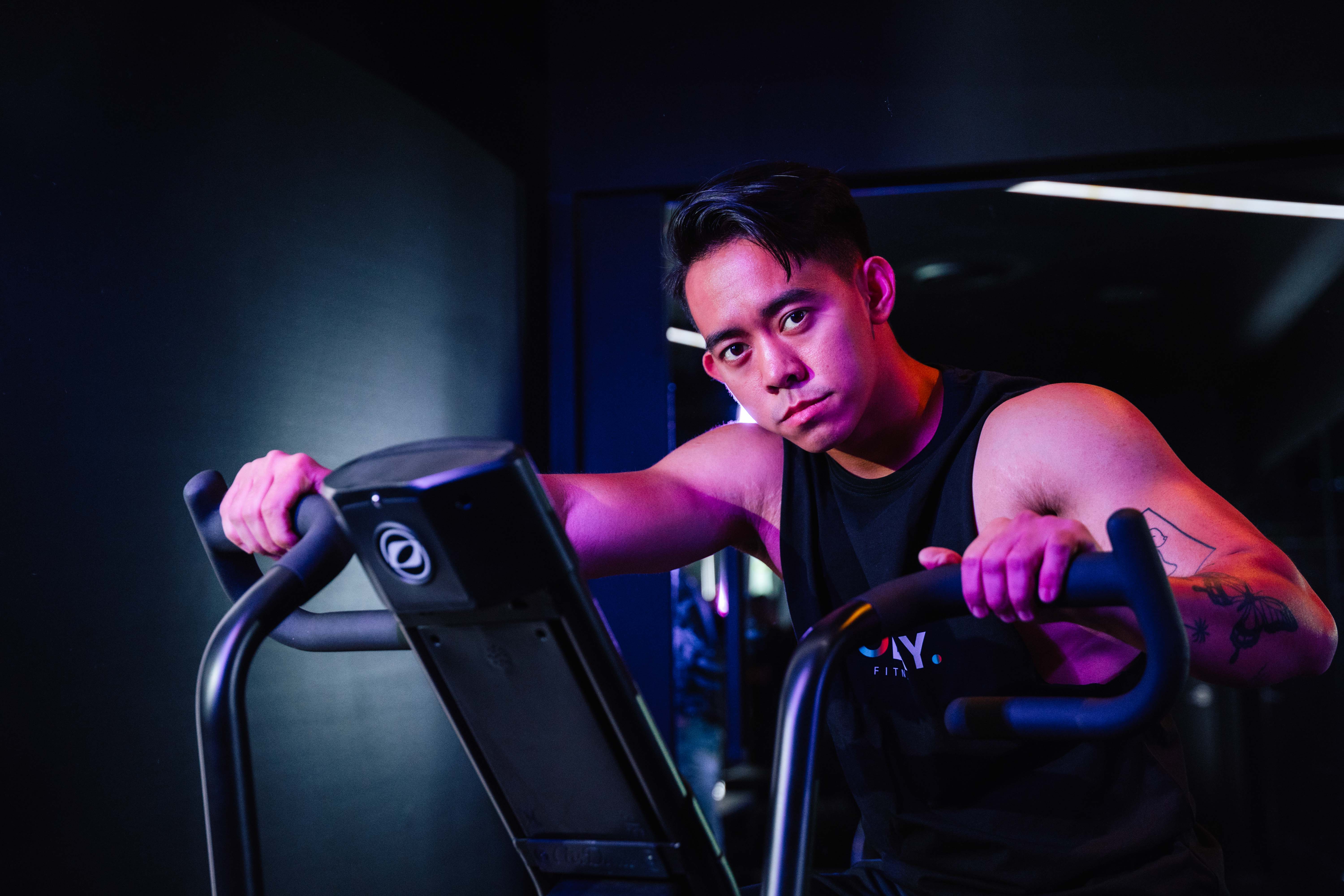 Rachel, personal trainer, looking to the side confidently in a fitness studio