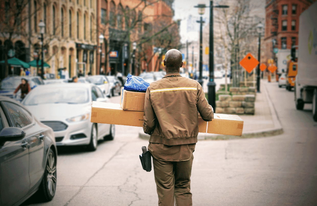 Courier delivering parcels with shipping labels