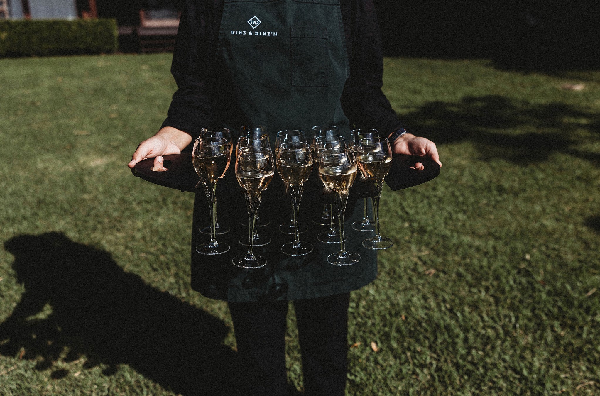 Bar staff serving champagne on arrival at an outdoor event