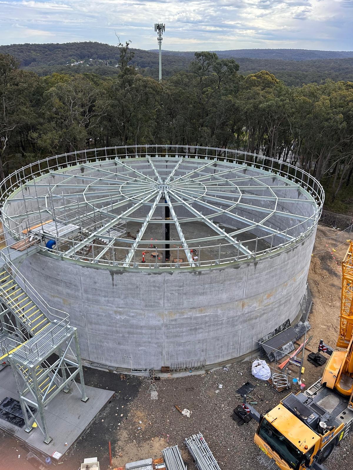 Concrete tank under construction with metal roof structure